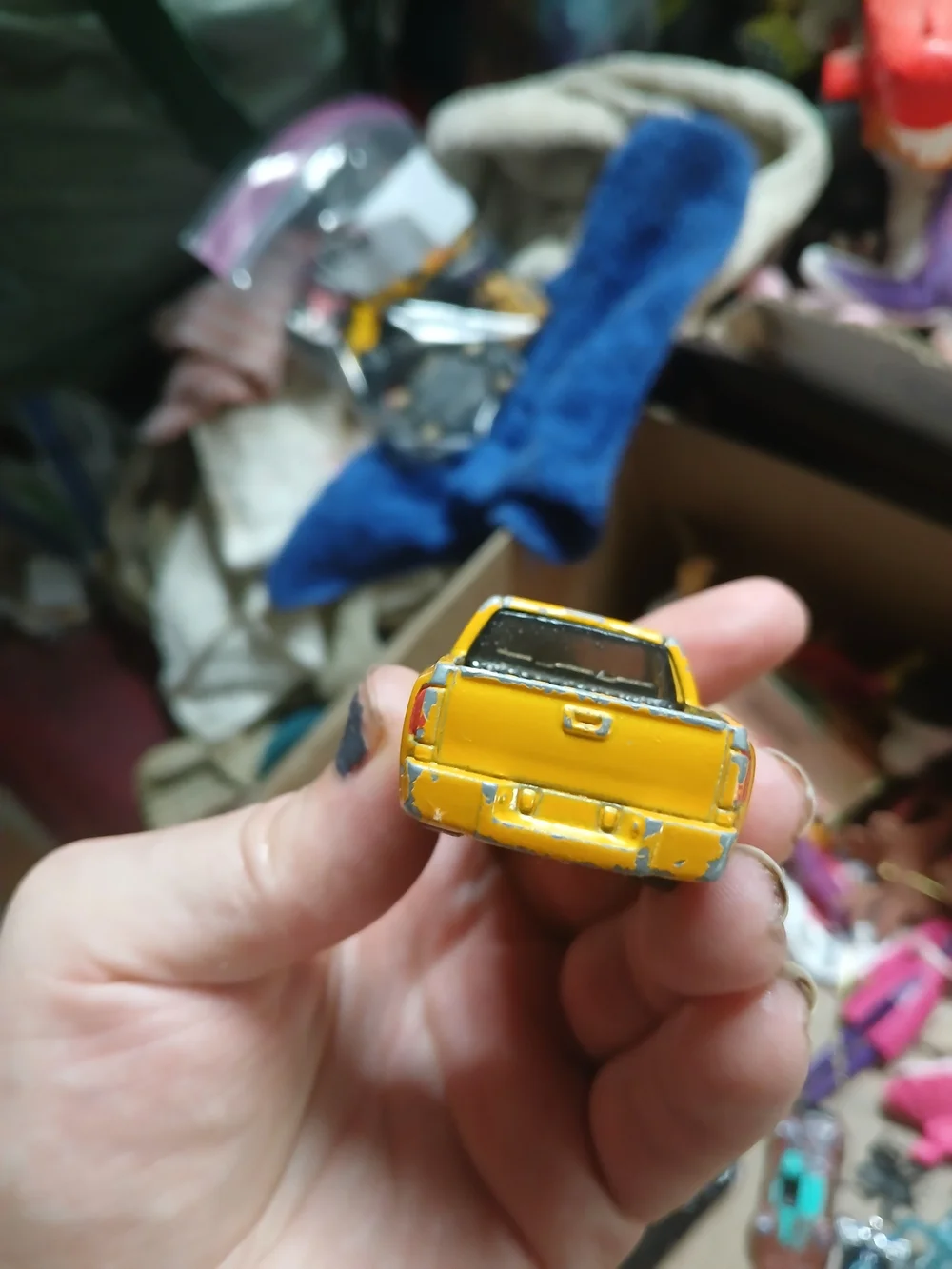 yellow 1:64 scale Hot Wheels Chevy Silverado,
